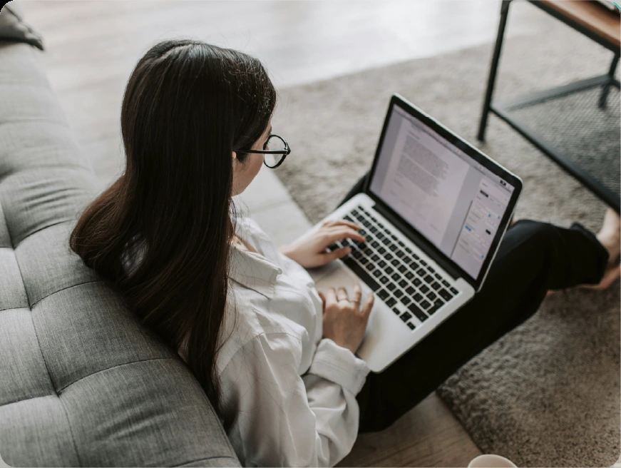 A woman reviewing operational documentation on a laptop after deployment.